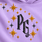 Approved official PG monogram close-up on lilac fabric with simulated black glitter texture; surrounding gold and charcoal stars.